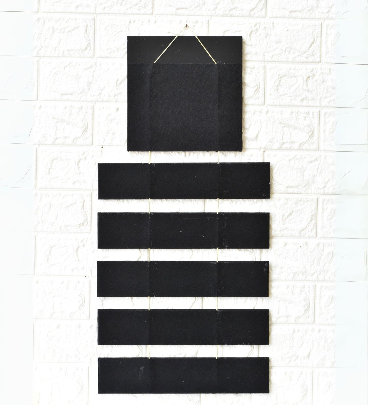 Set of black rectangular tiles on a textured white surface
