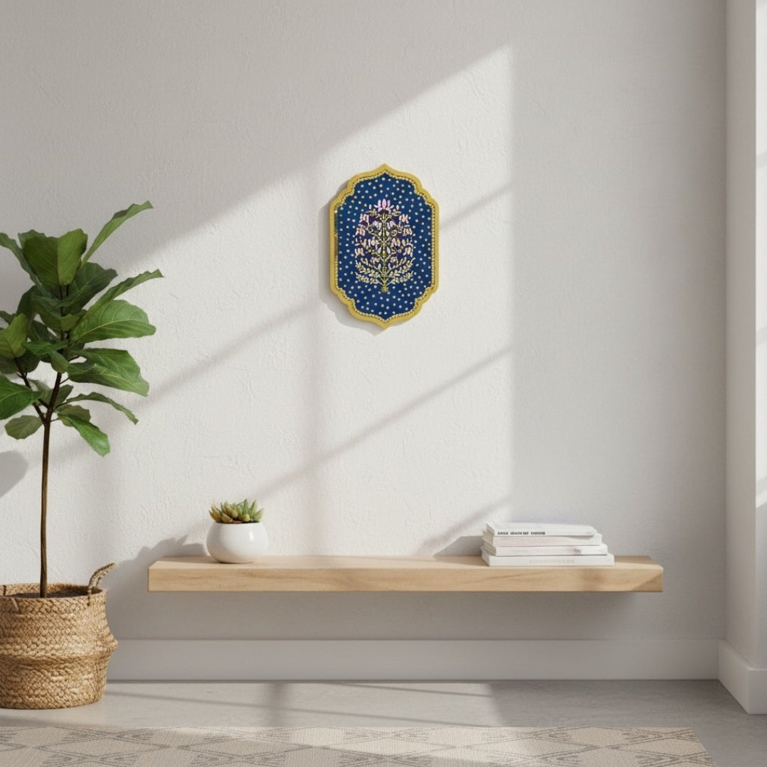 Modern interior with a wooden shelf, potted plant, and with Indian Ethnic wall art in blue with gold mirrors and gold accent