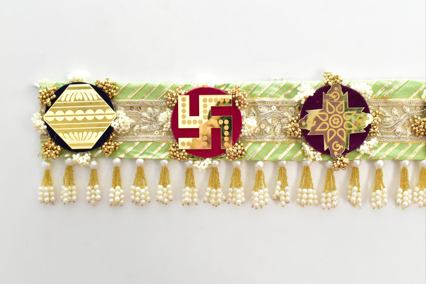 Green handcrafted Ashthamangala toran with traditional mirror work and 8 sacred symbols, ideal for ethnic home décor, door hanging, or pooja room decoration