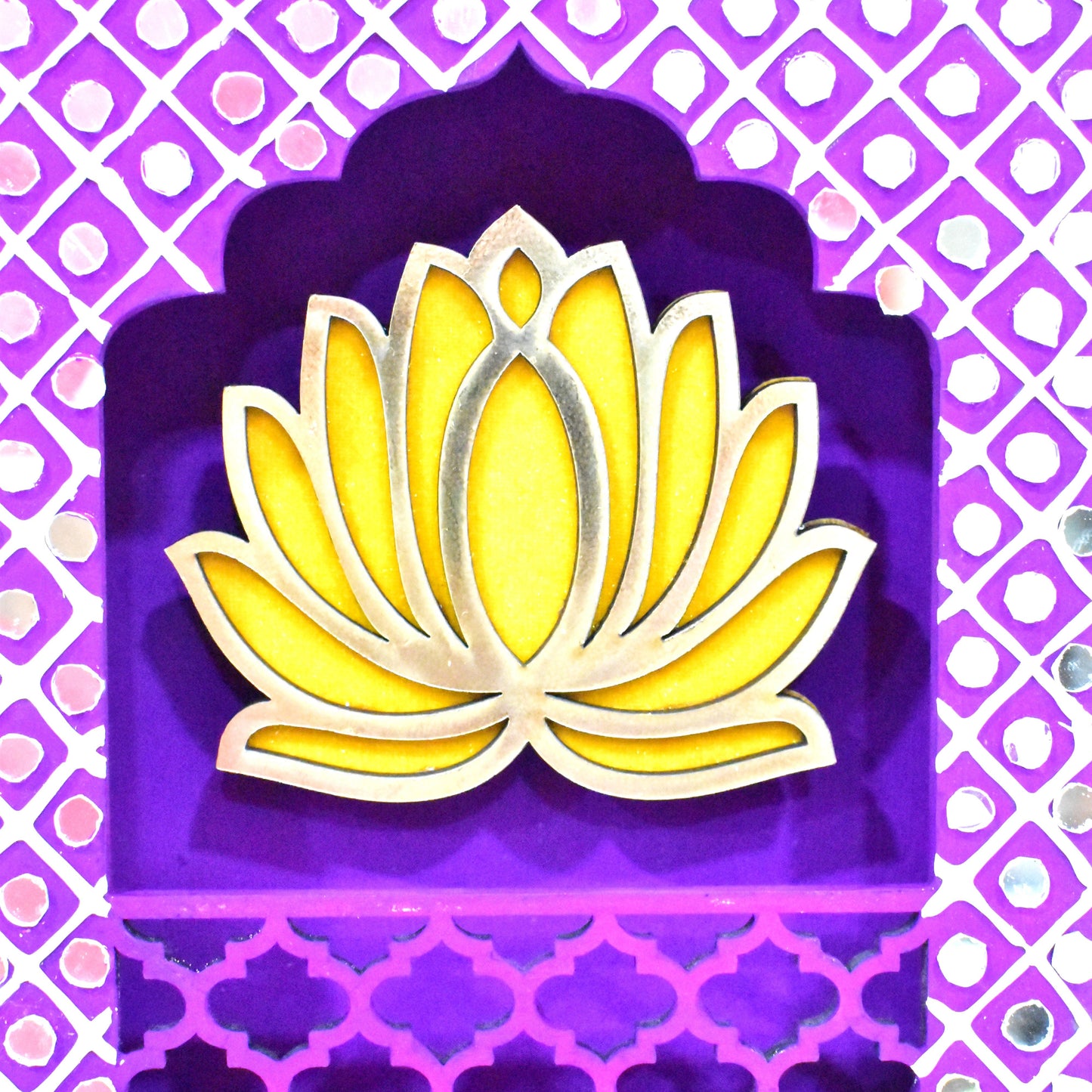Close up of handmade Lotus Jharokha Wall Hanging with a purple background, yellow lotus flower, and decorative elements including tassels.