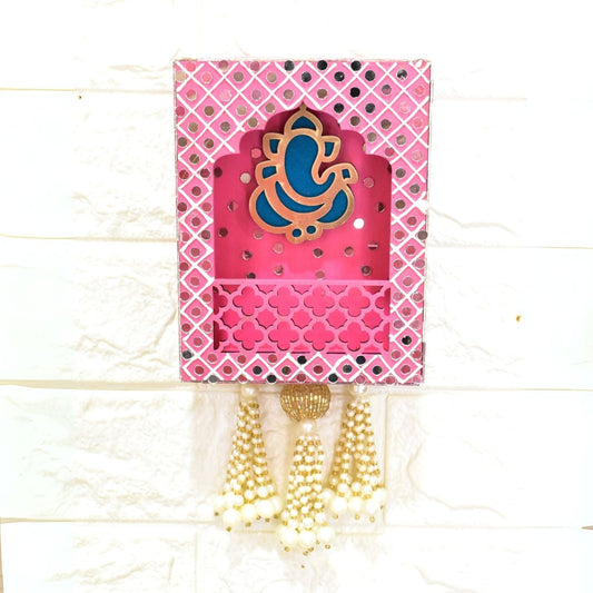 Pink decorative wall hanging with a blue and gold design on a white background