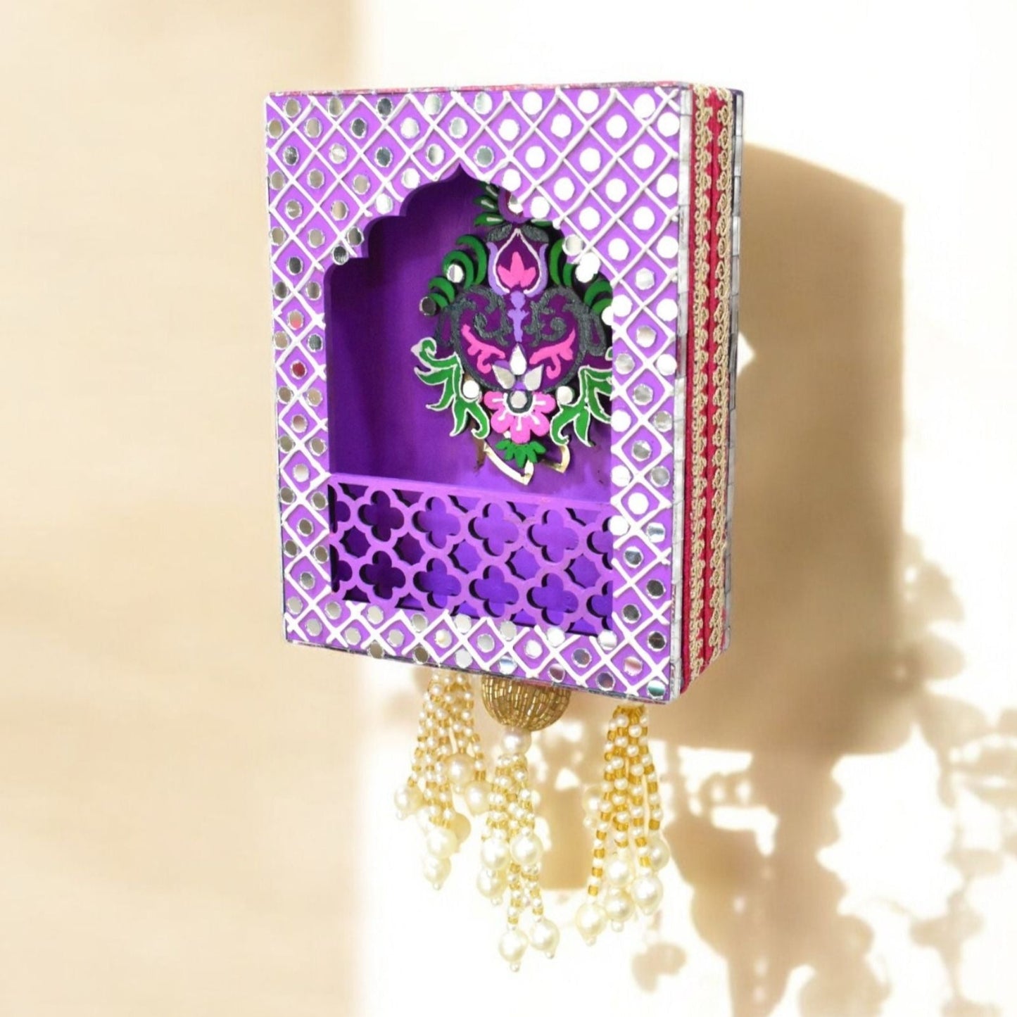 Decorative purple shelf with intricate designs on a beige background