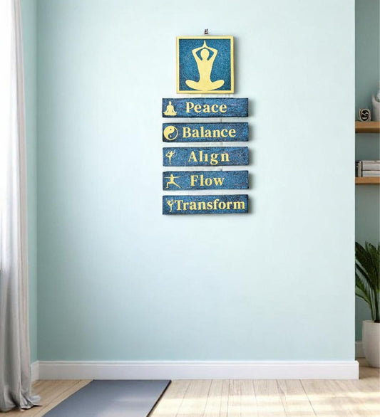 Yoga-themed wall art with motivational phrases on a light blue wall.