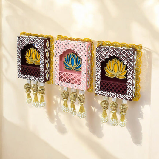 Three rectangular Indian jharokha wall hangings with lotus motifs, decorative patterns, and tassels, displayed against a light background.