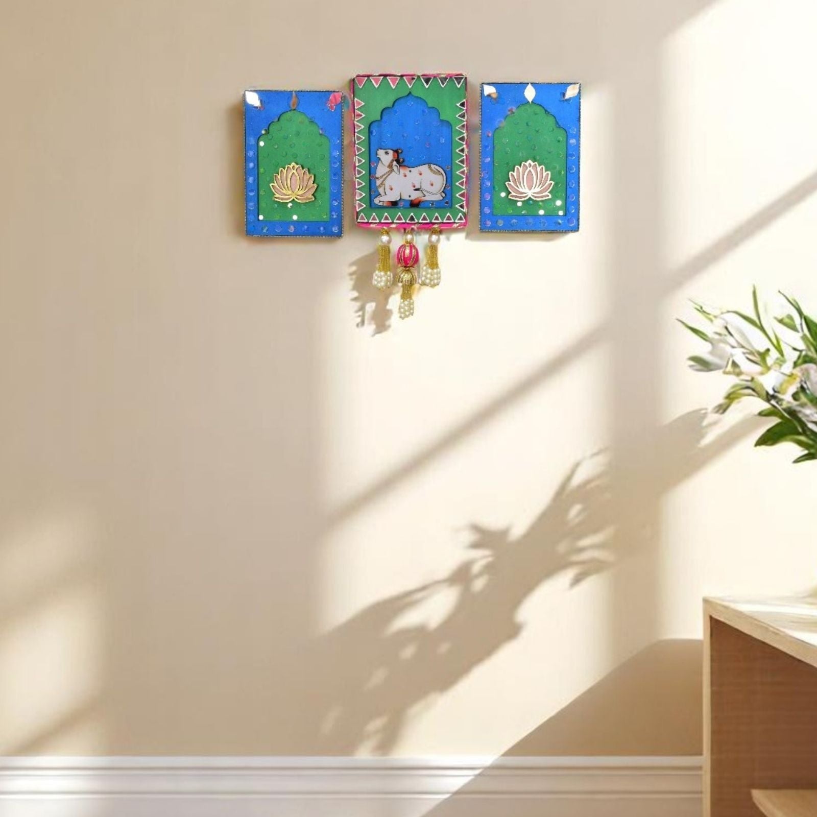 Decorative wall art with colorful frames on a beige wall.
