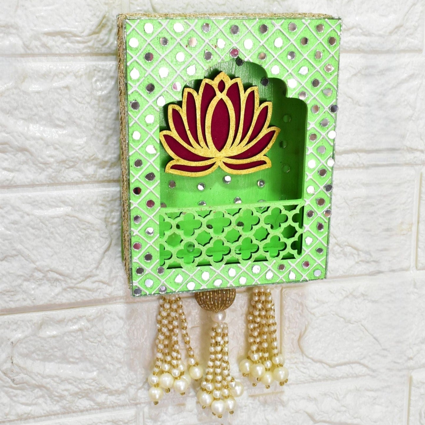 Decorative wall hanging with a lotus design on a green background