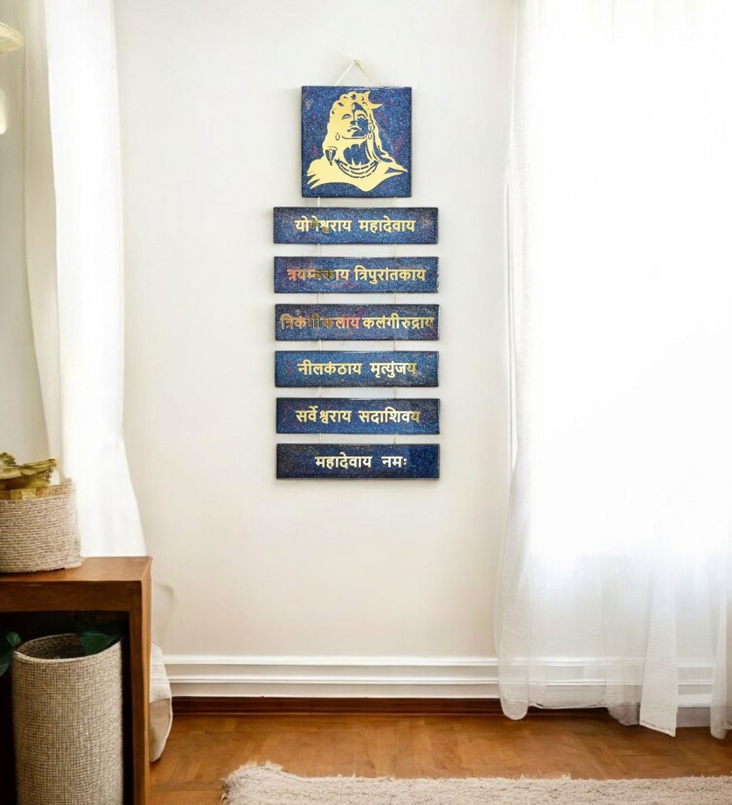 Decorative shiva wall art with blue and gold elements on a white wall.