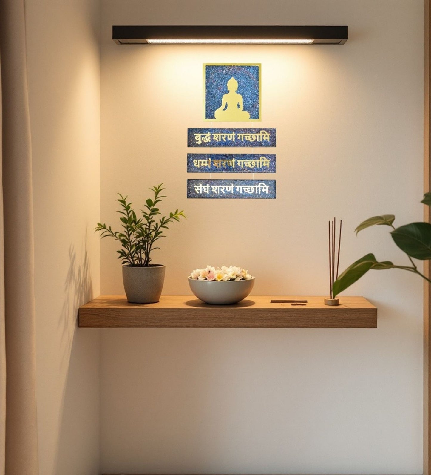 Wall-mounted shelf with a plant, bowl, and decorative items against a light wall.