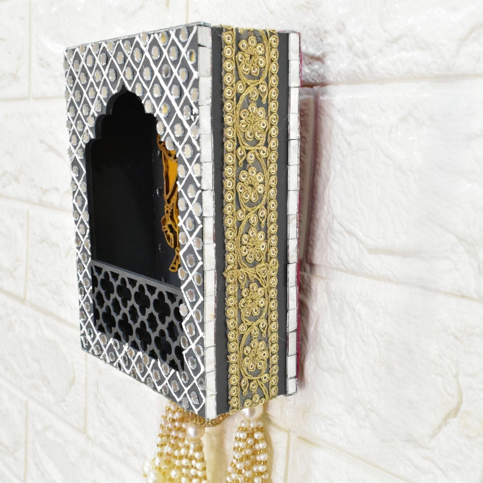 Decorative box with intricate patterns and gold accents on a textured white background