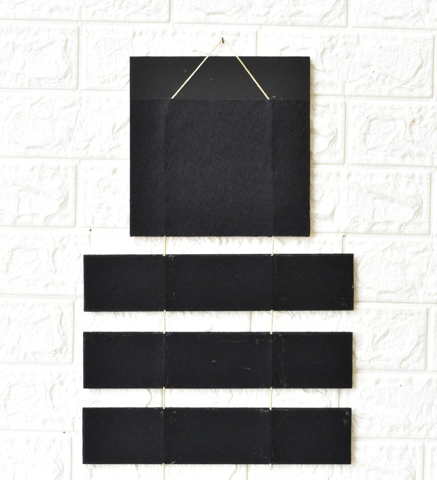 Set of black rectangular tiles on a white tiled wall