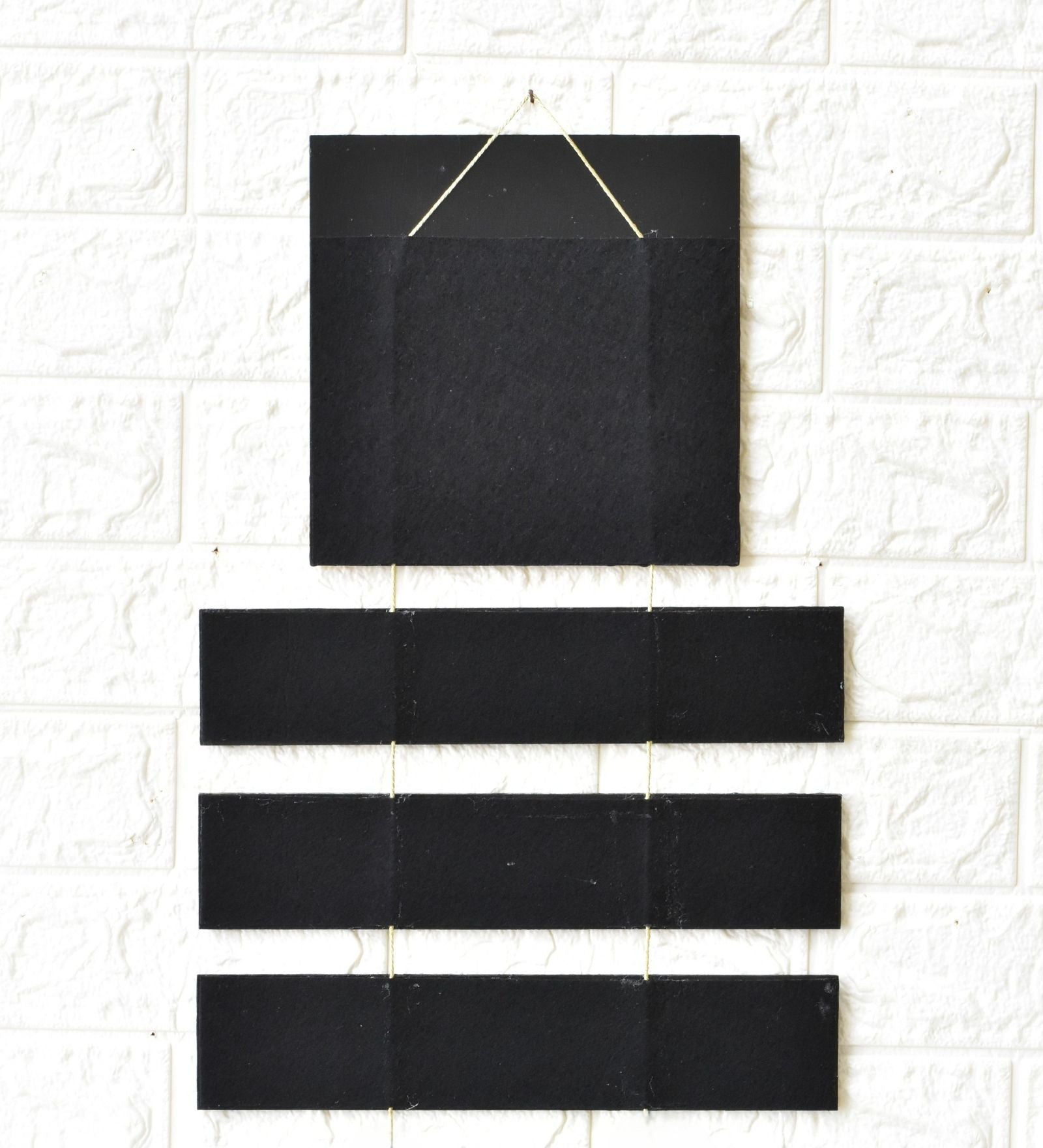 Set of black rectangular tiles on a white tiled wall