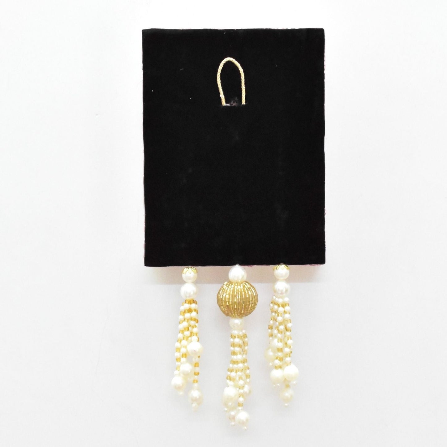 Pair of pearl and gold beaded hanging on a black card against a white background
