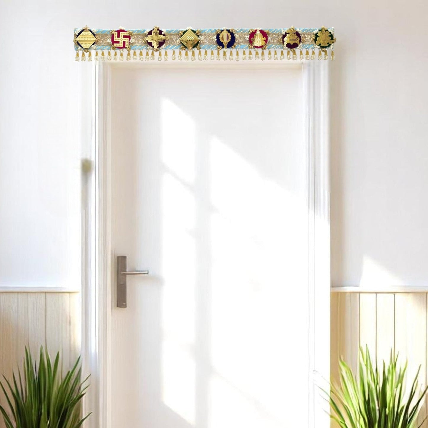 Modern interior with a white door, plants, and decorative toran ashtamangal jain gift.