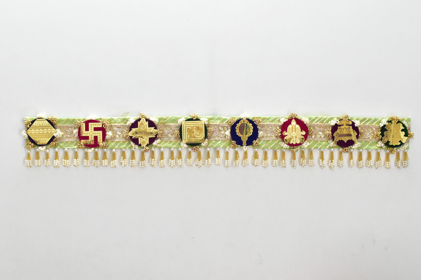 Green handcrafted Ashthamangala toran with traditional mirror work and 8 sacred symbols, ideal for ethnic home décor, door hanging, or pooja room decoration