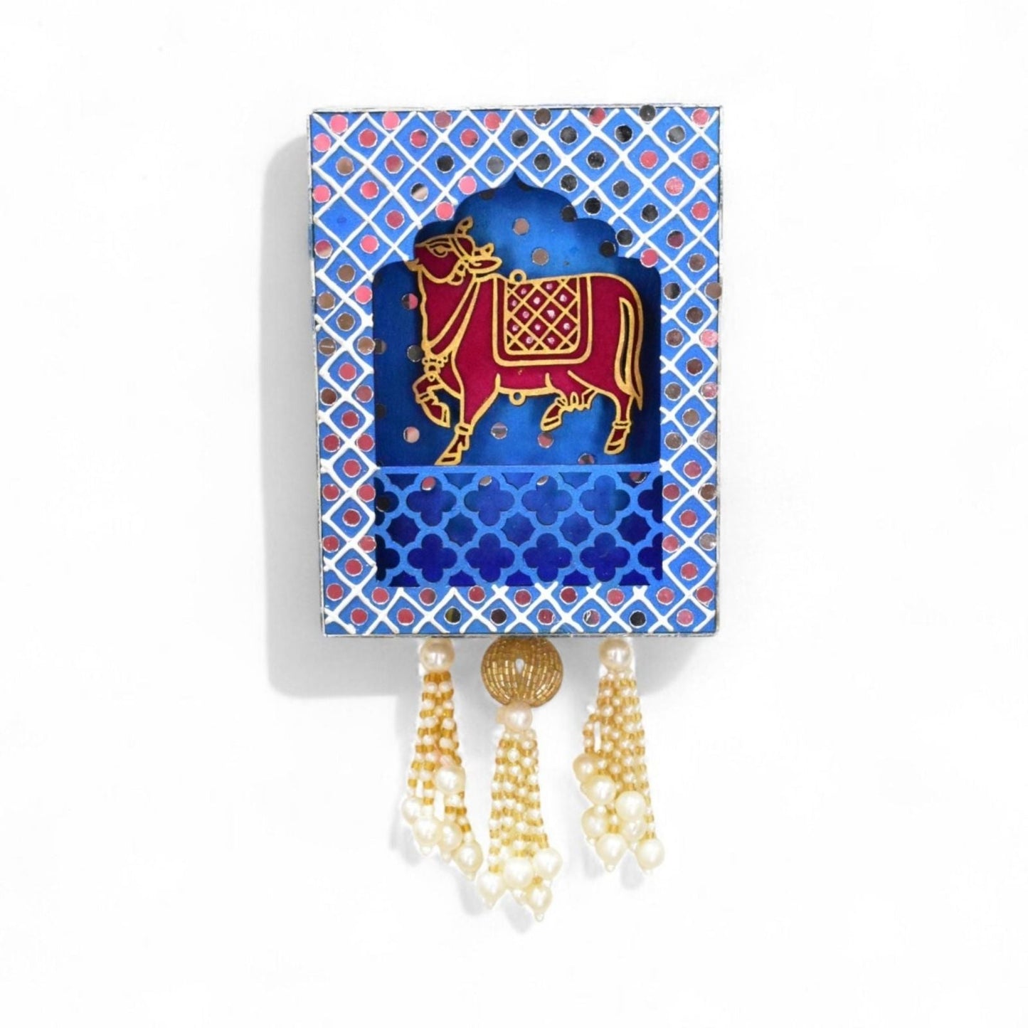Blue decorative wall jharokha hanging with a cow in the centre and mirror and pearl beads.