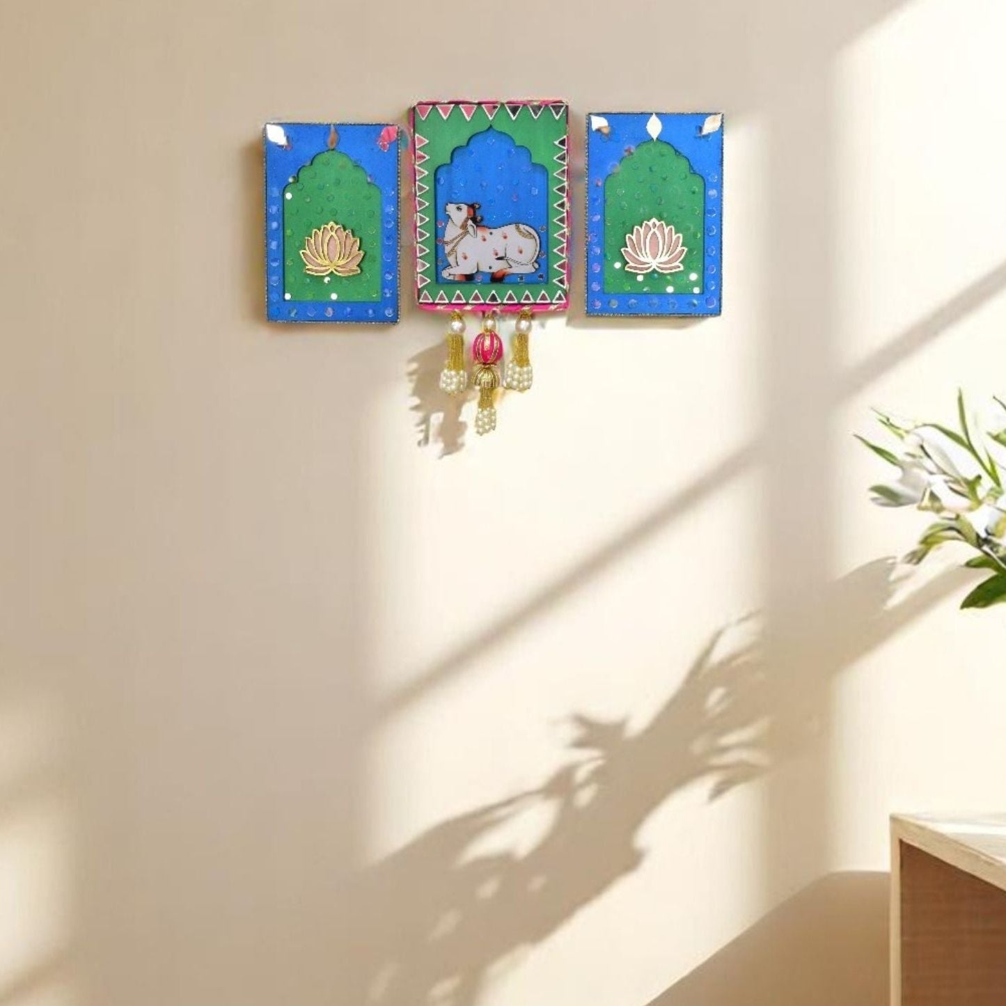 Blue & Green Decorative wall hangings jharokha with lotus and cow designs in on a living room.