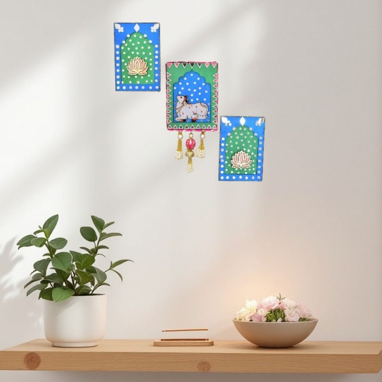 Blue & Green jharokha Decorative wall hangings with a plant and bowl on a shelf against a white wall.