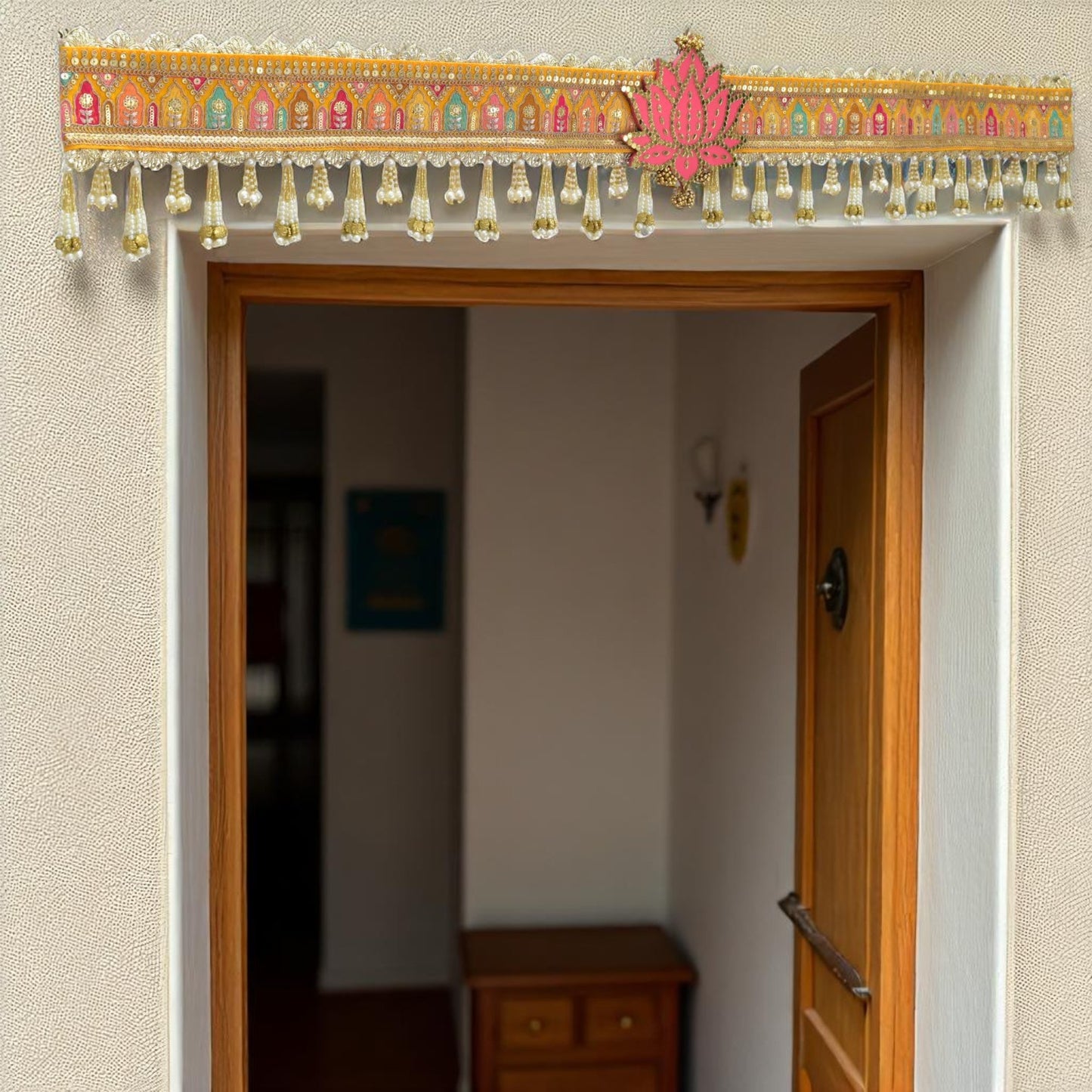 Decorative door hanging toran with colorful patterns and beads above an open door