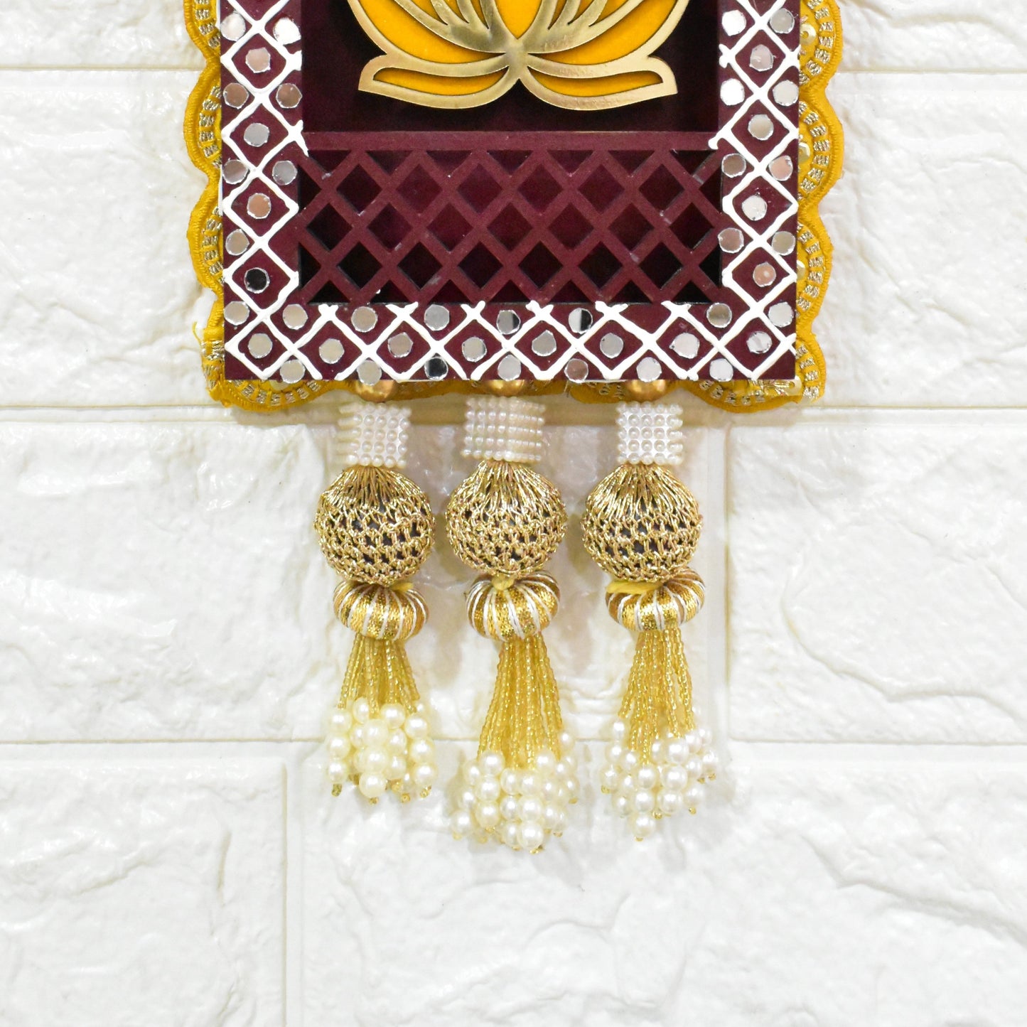 Three rectangular Indian jharokha wall hangings with lotus motifs, decorative patterns, and tassels, displayed against a light background.