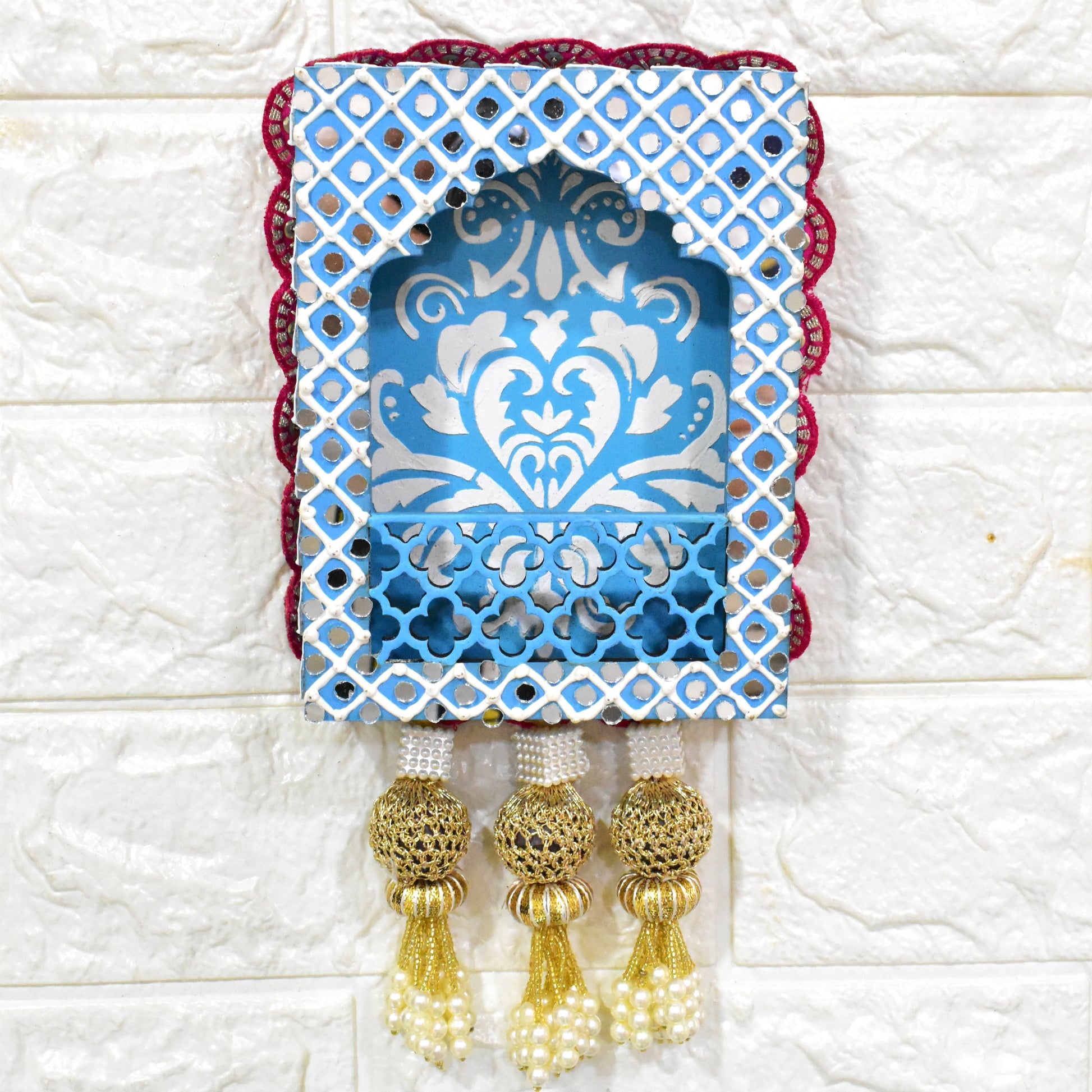 A handcrafted floral jharokha wall hanging with pearl tassels, featuring intricate floral cutwork and vibrant hand-painted patterns on premium MDF wood.