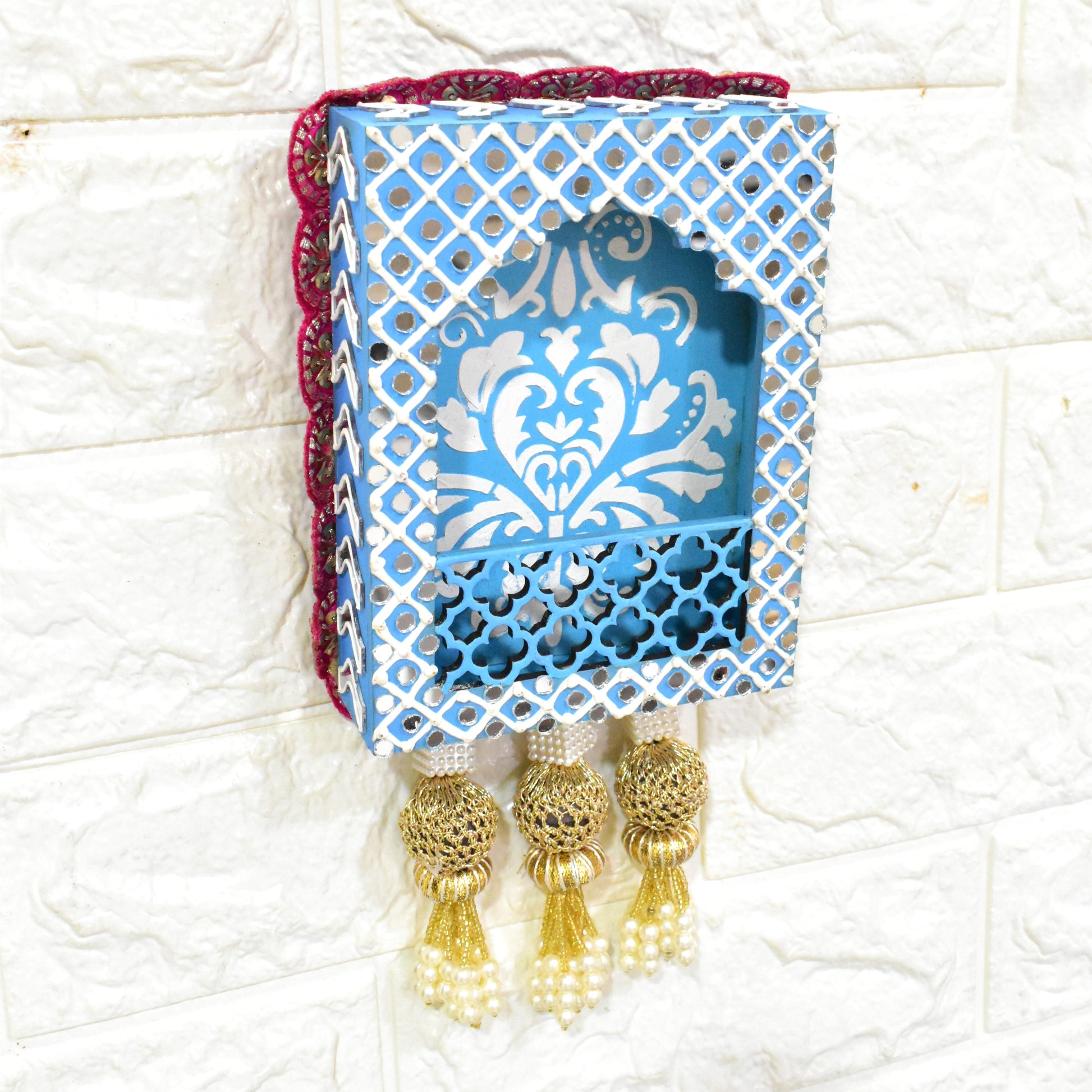 A handcrafted floral jharokha wall hanging with pearl tassels, featuring intricate floral cutwork and vibrant hand-painted patterns on premium MDF wood.