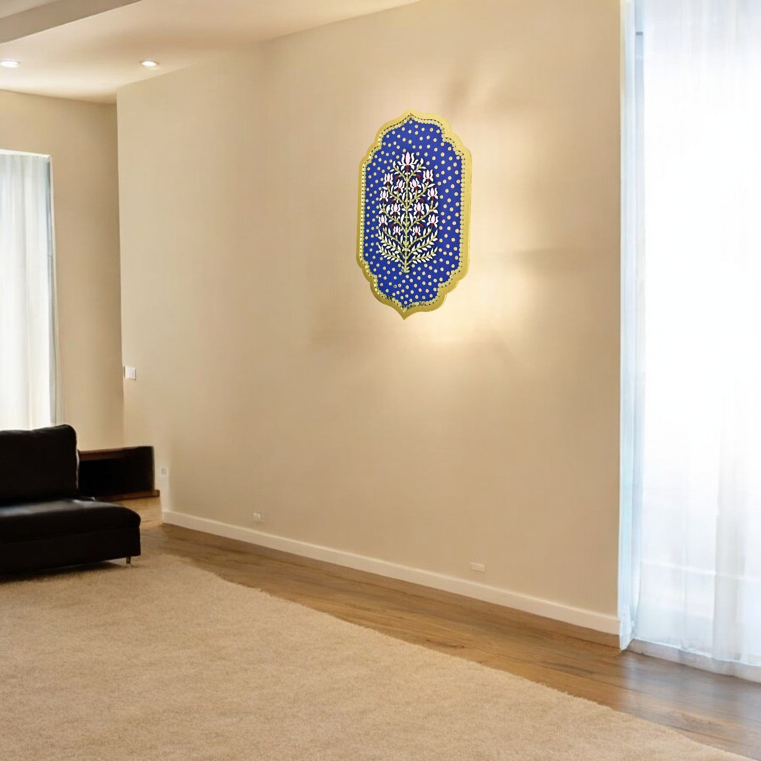 Decorative wall art on a beige wall in a room with a black sofa and white curtains.