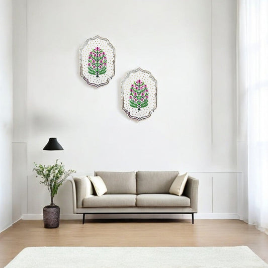 Living room with a gray sofa, decorative pillows, and wall art featuring floral designs.
