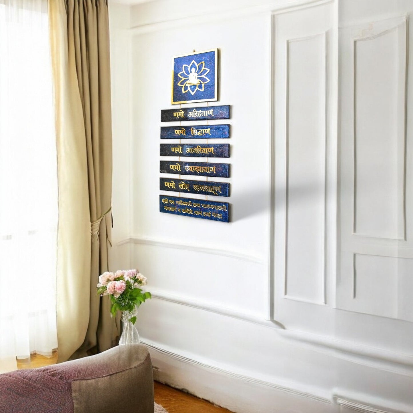 Decorative wall art with blue and gold elements in a room with a curtain and vase.