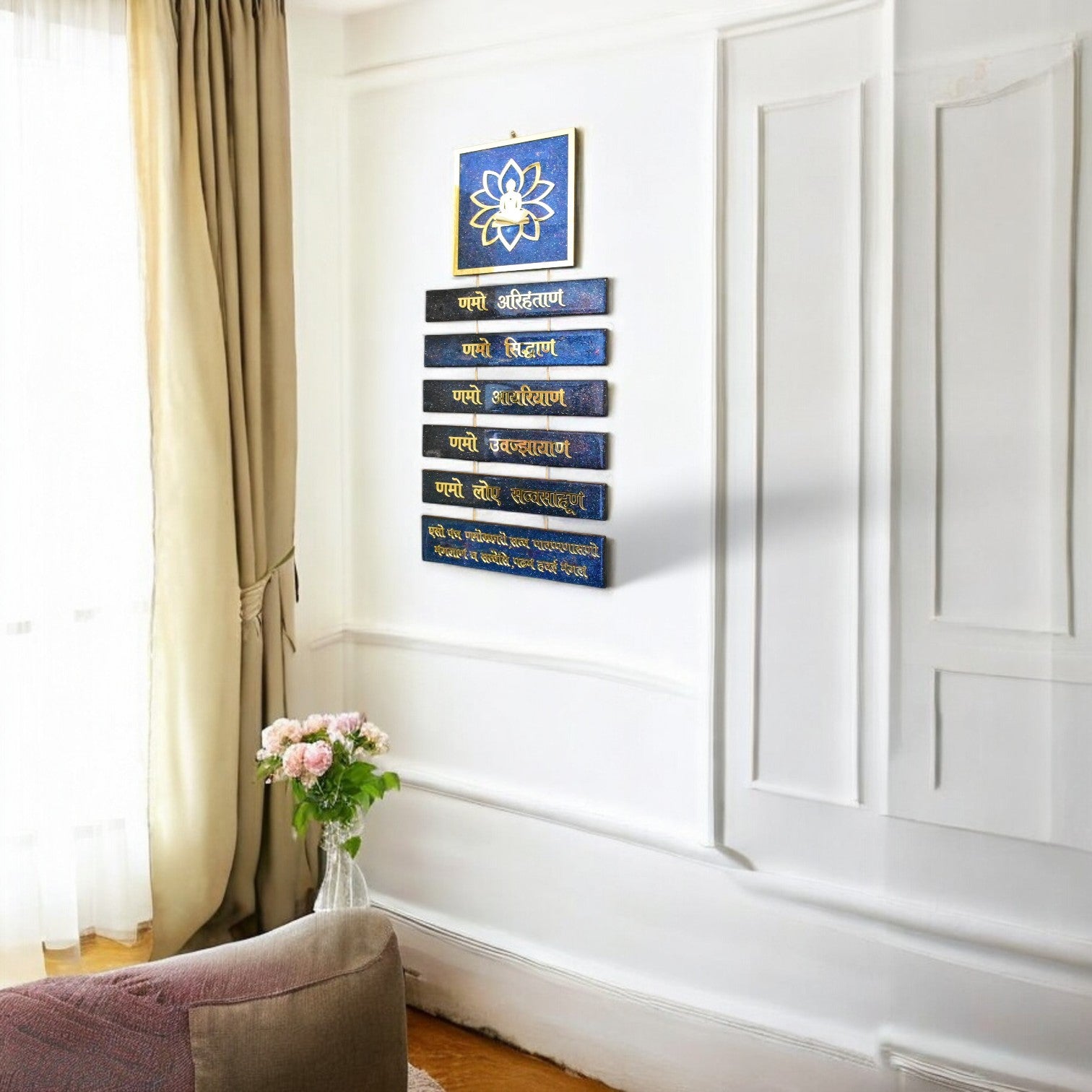 Decorative wall art with blue and gold elements in a room with a curtain and vase.