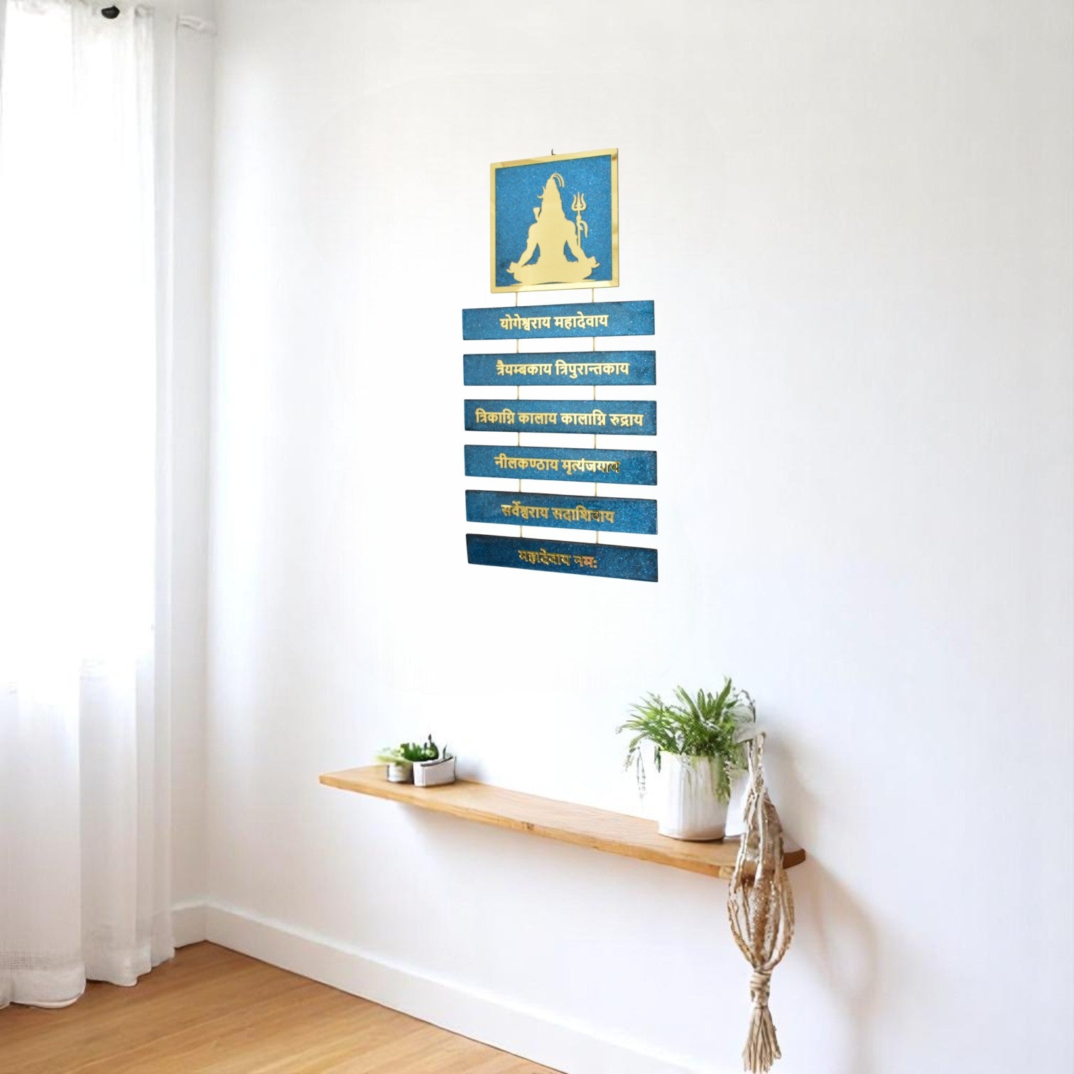 Shiva wall art with a blue and gold design on a white wall.