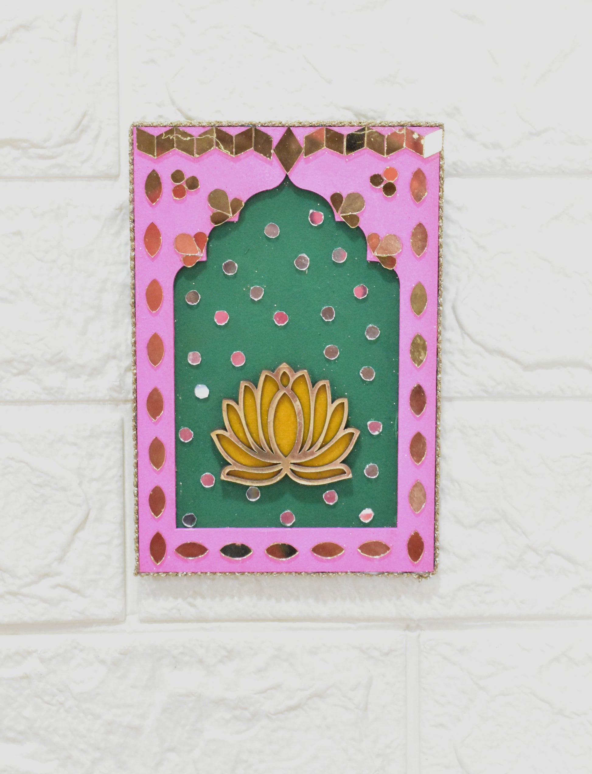 Decorative plaque with a yellow lotus flower design on a green background with pink border