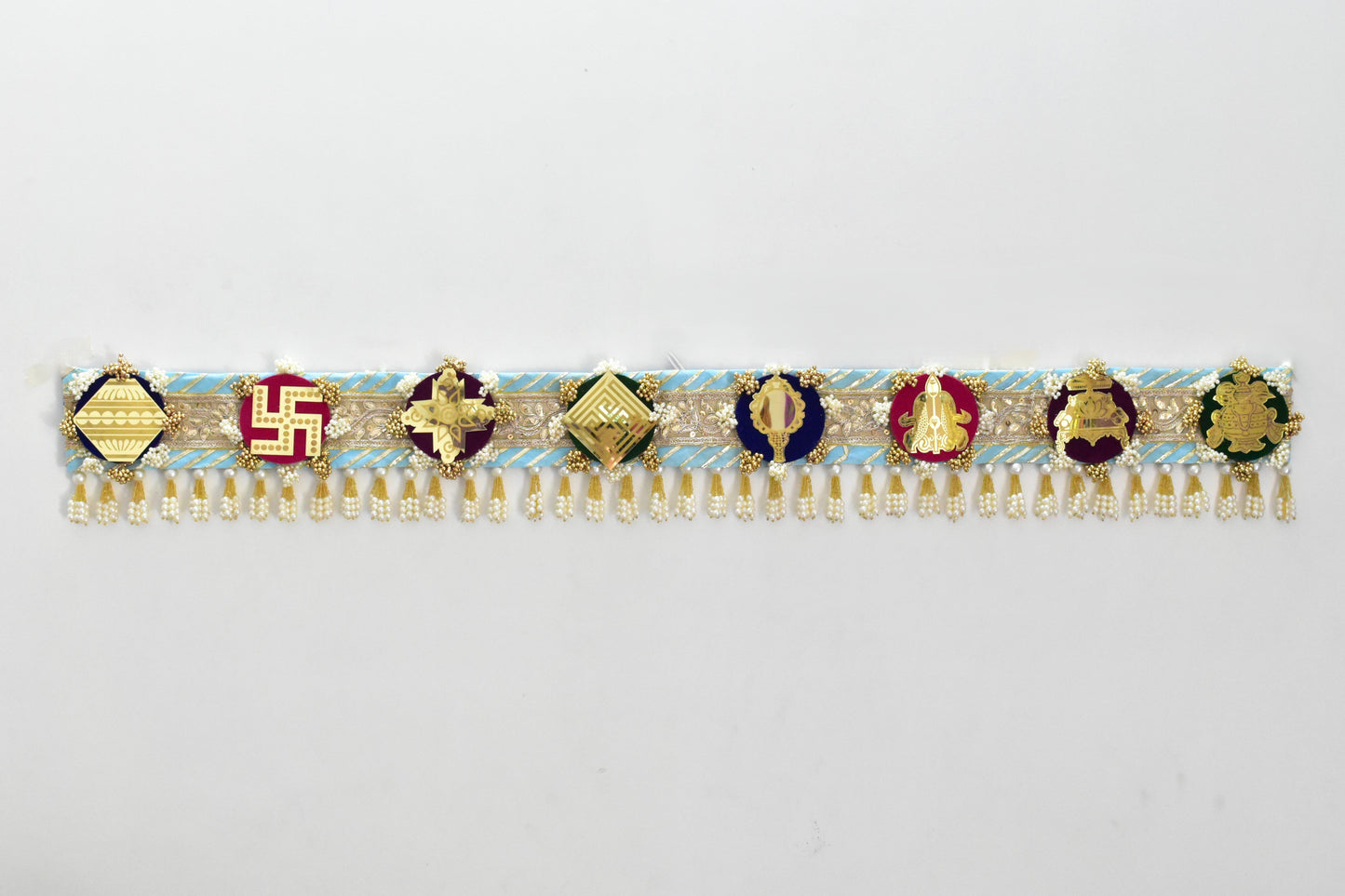 Decorative Toran with jain ashtamangal theme and colorful stones on a blue background