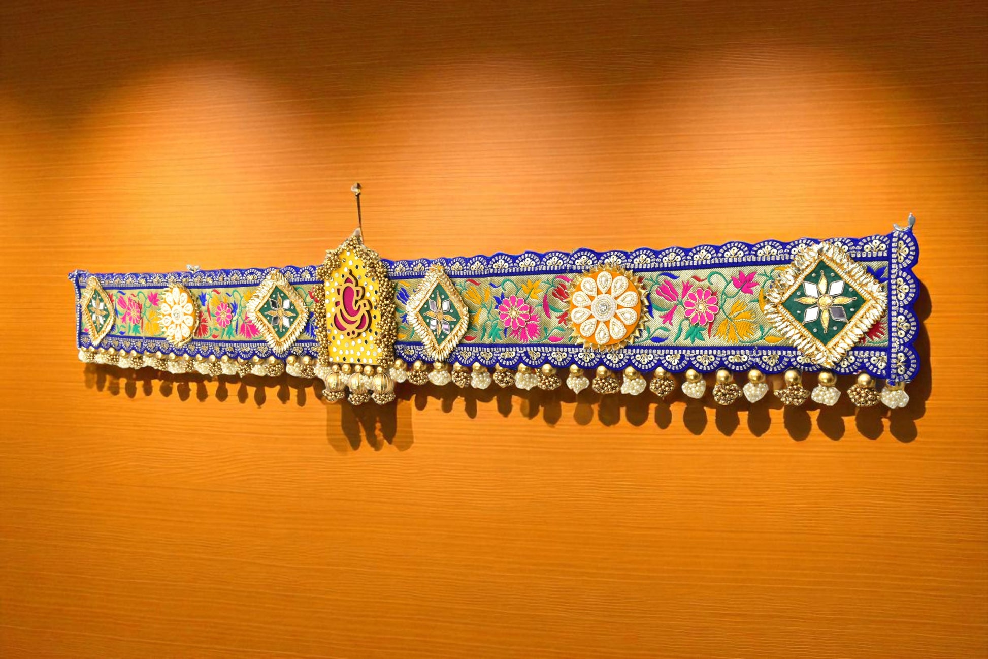 Decorative toran with floral and geometric patterns 