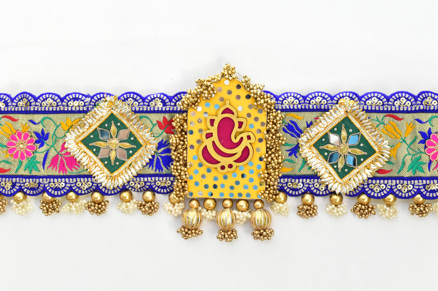 Decorative Ganpati toran with colorful patterns and gold accents on a white background