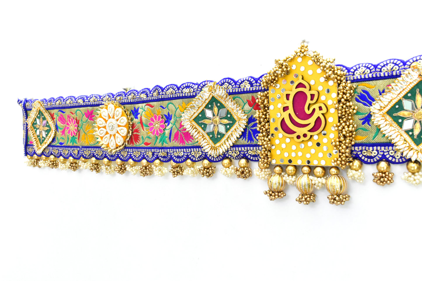 Decorative Ganpati Toan with colorful patterns and gold accents on a white background