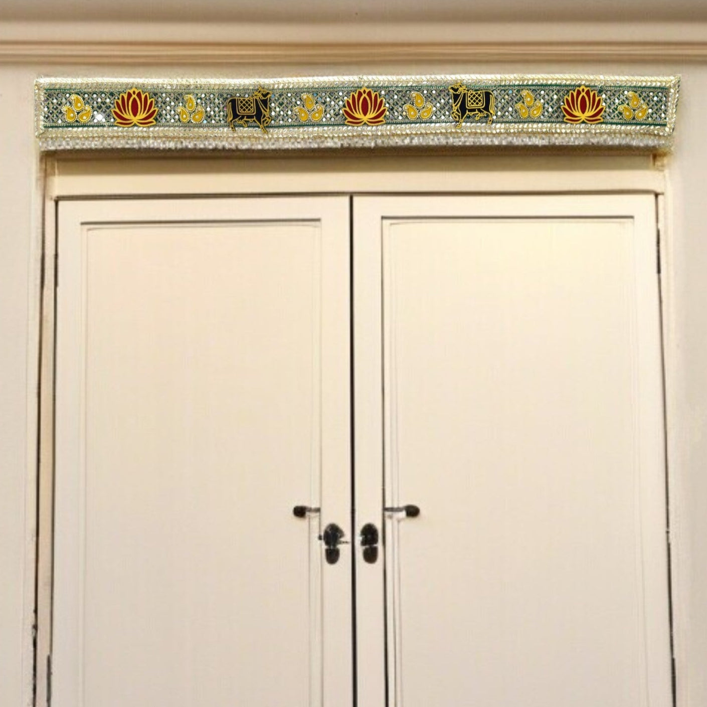 Decorative toran above a door with floral patterns