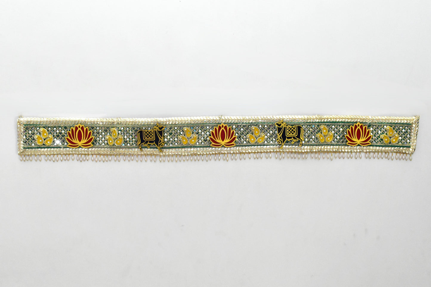 Decorative toran with cow and floral patterns on a white background