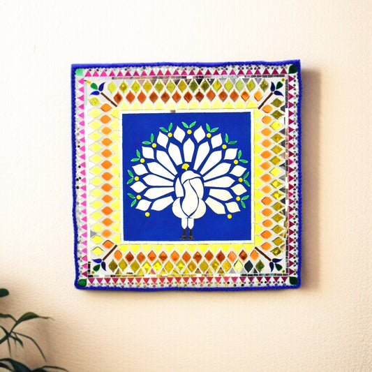 Decorative wall art with a peacock design on a colorful geometric border.