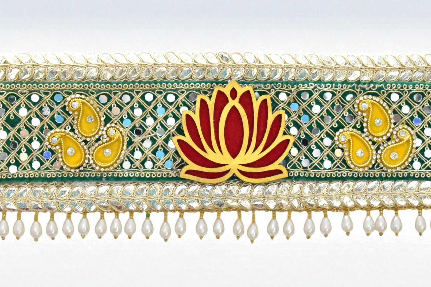 Decorative toran with lotus flower and paisley patterns on a white background