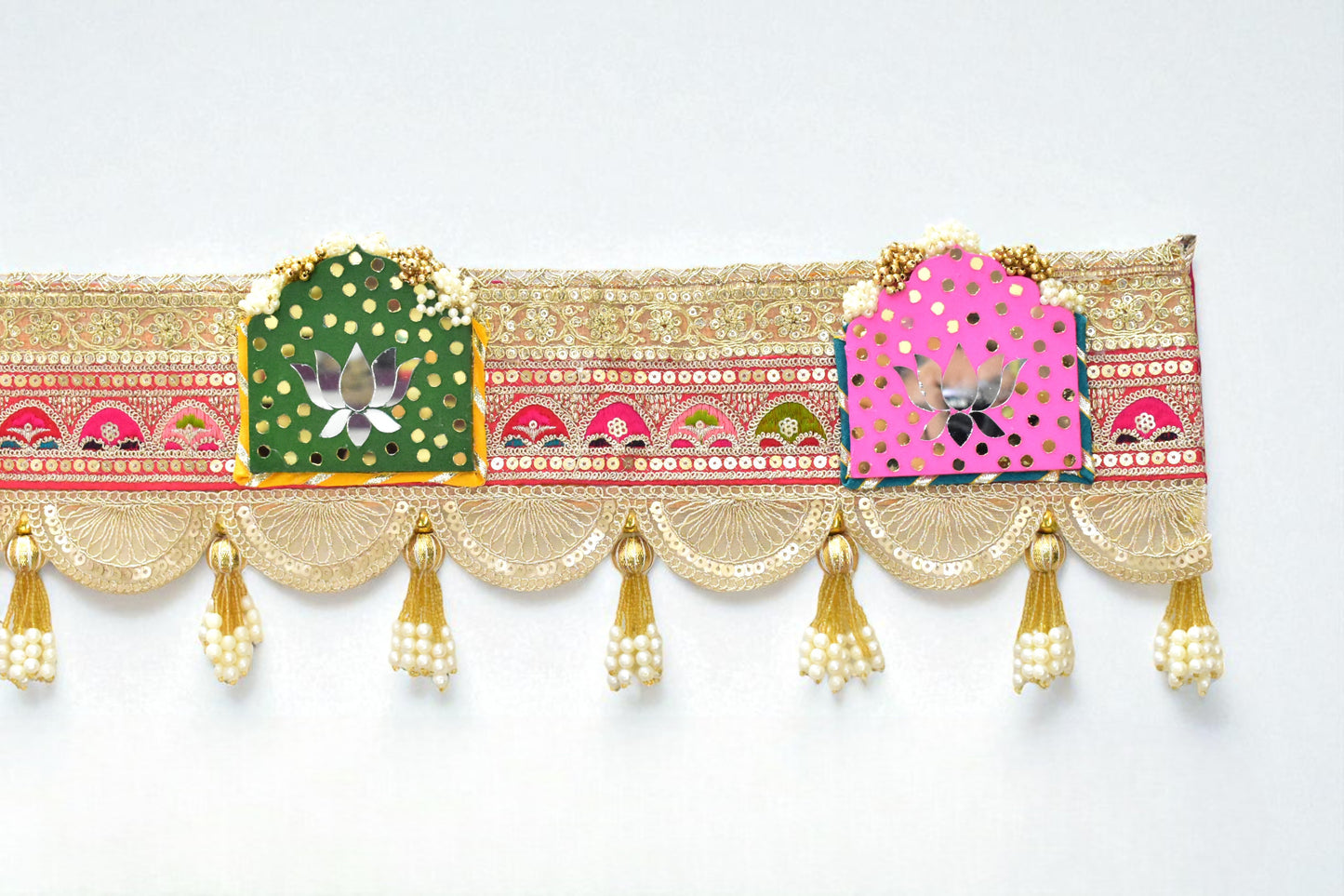 Decorative door hanging with colorful patterns and gold tassels on a white background