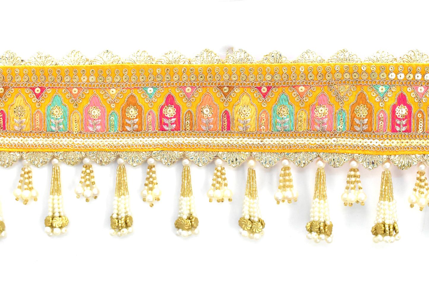 Decorative door toran hanging with colorful patterns and gold tassels on a white background
