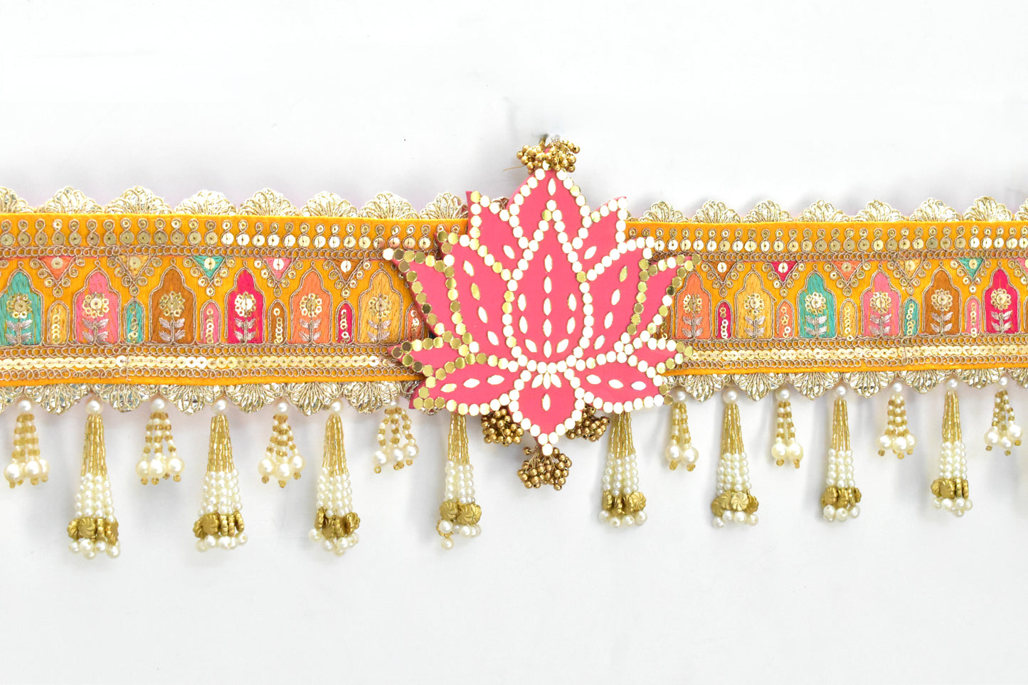 Decorative toran hanging with pink lotus flower and colorful patterns on a white background