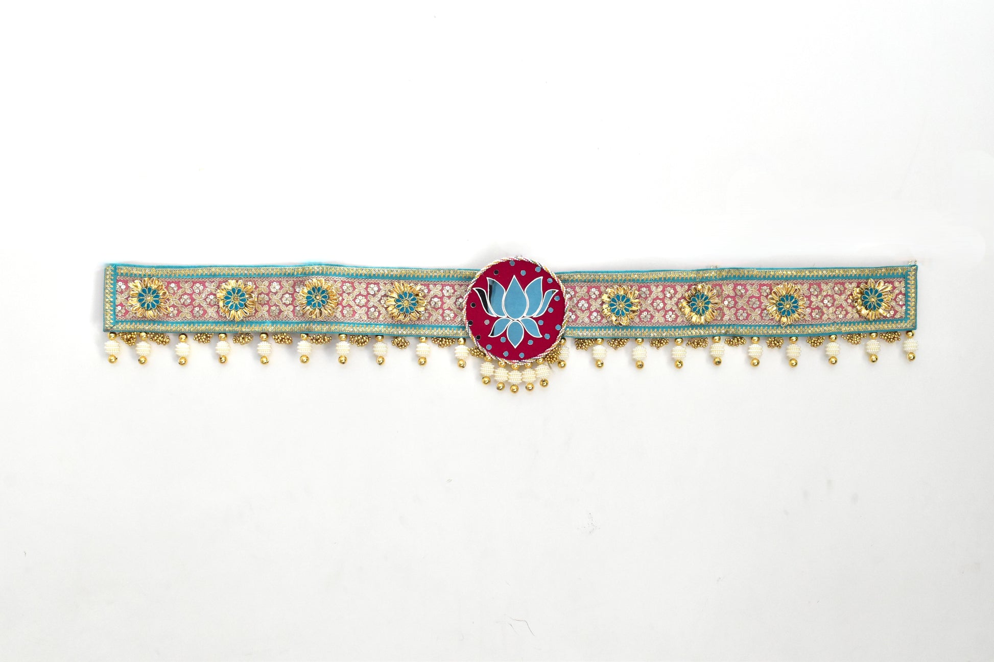 Decorated toran door hanging with floral patterns and a central lotus design on a white background