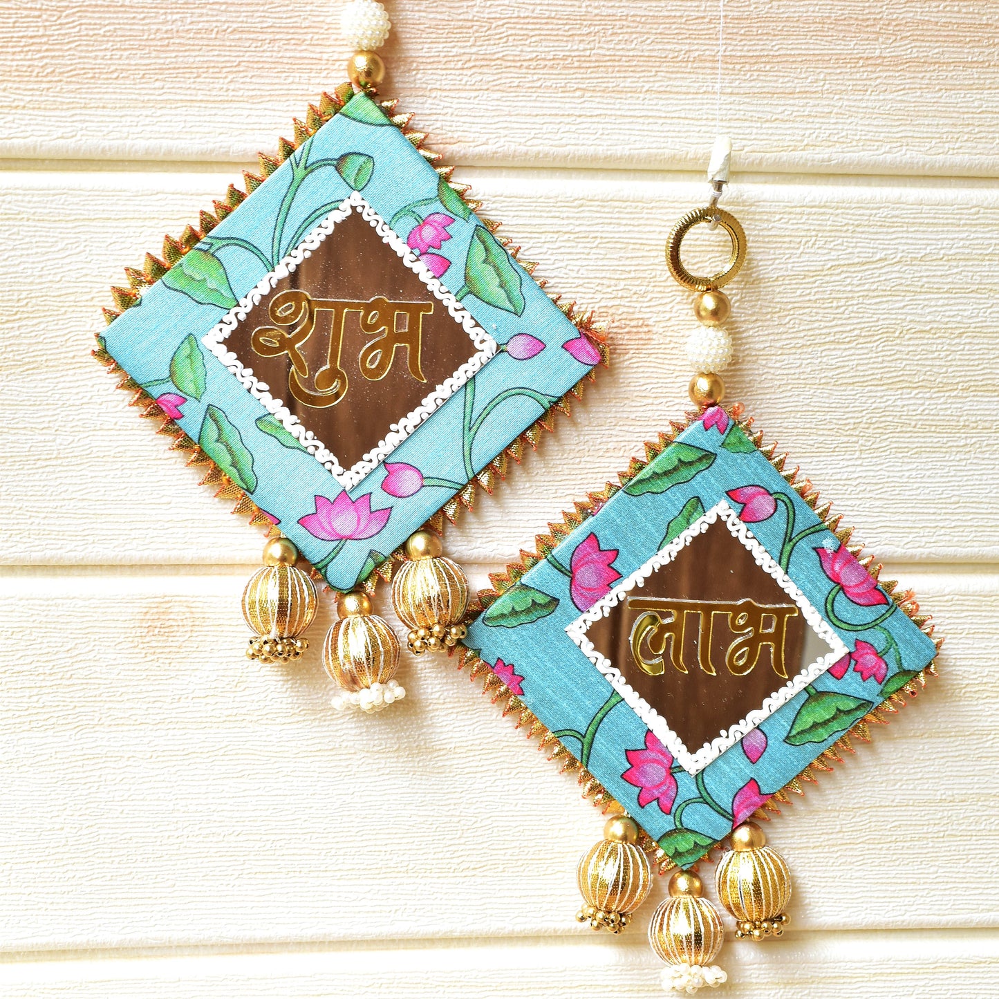 Pair of Shubh Labhs with floral patterns and gold accents