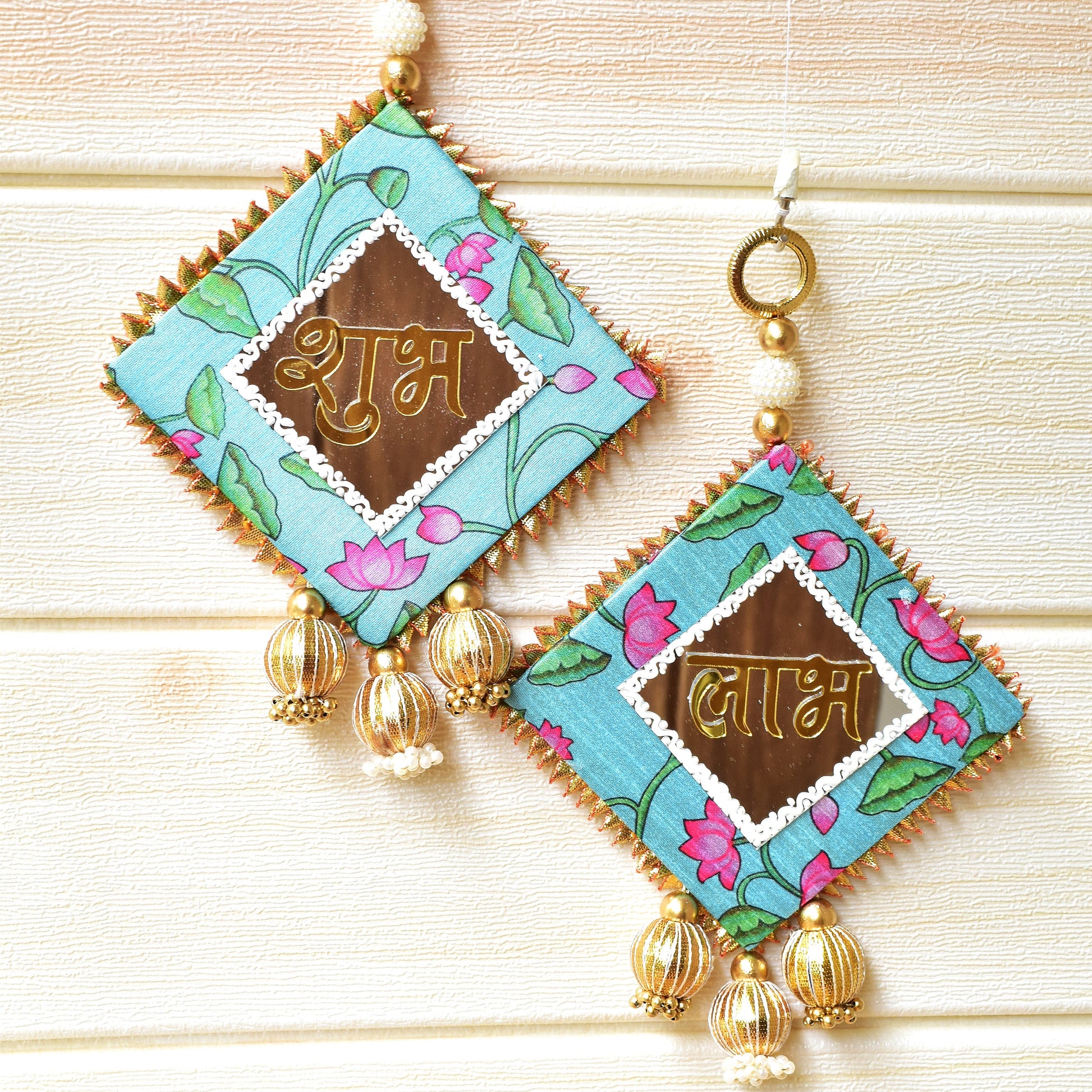 Pair of Shubh Labhs with floral patterns and gold accents