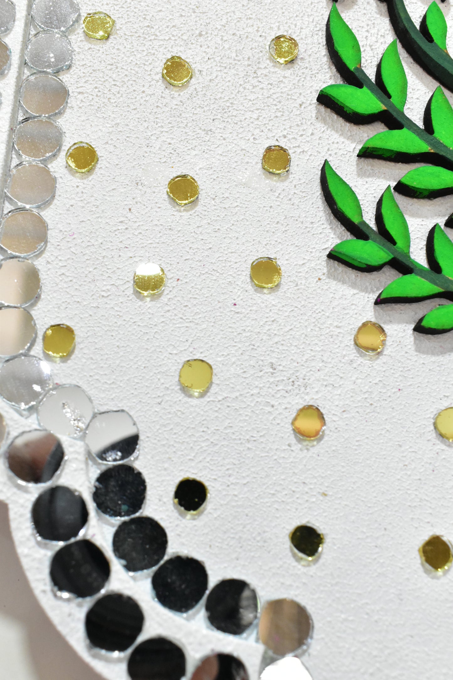 Decorative border with green leaves, gold and silver circles on a white background
