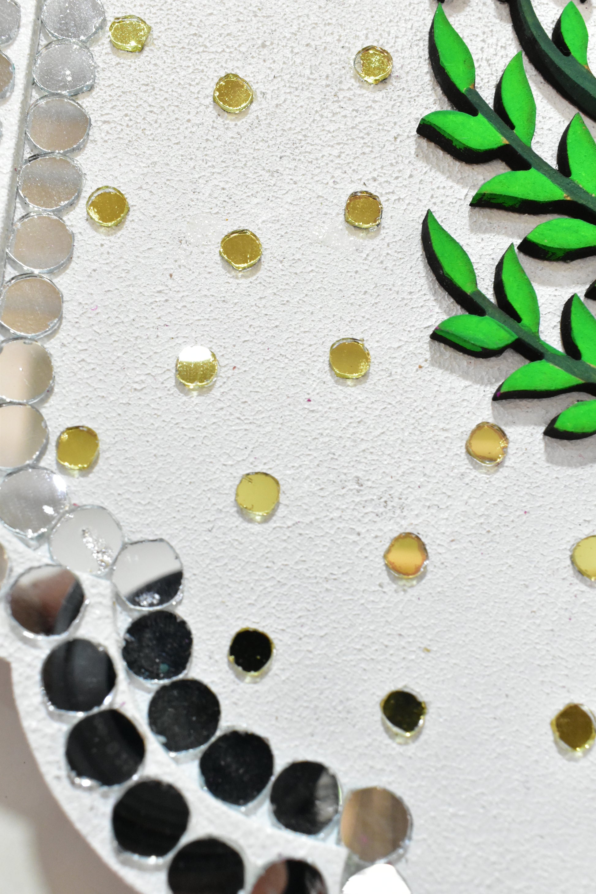Decorative border with green leaves, gold and silver circles on a white background