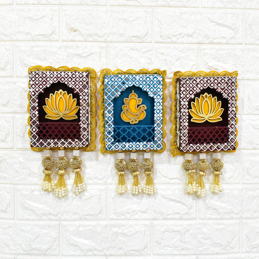A set of three wall hangings featuring Lord Ganesha with a lotus flower design, in blue, brown, and gold colors, with decorative elements.