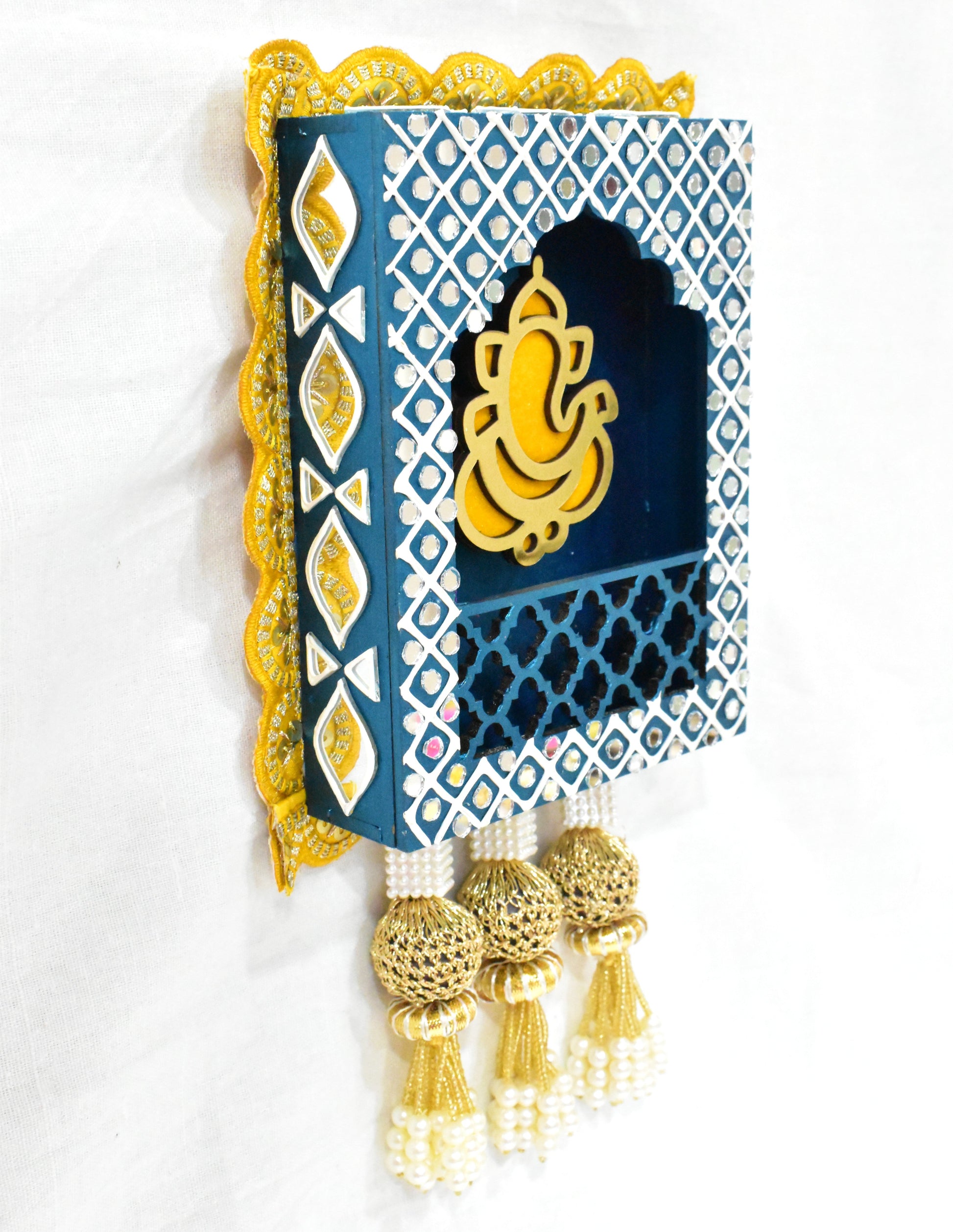 Close up of Ganesha jharokha wall hanging in bluw colour on a white background