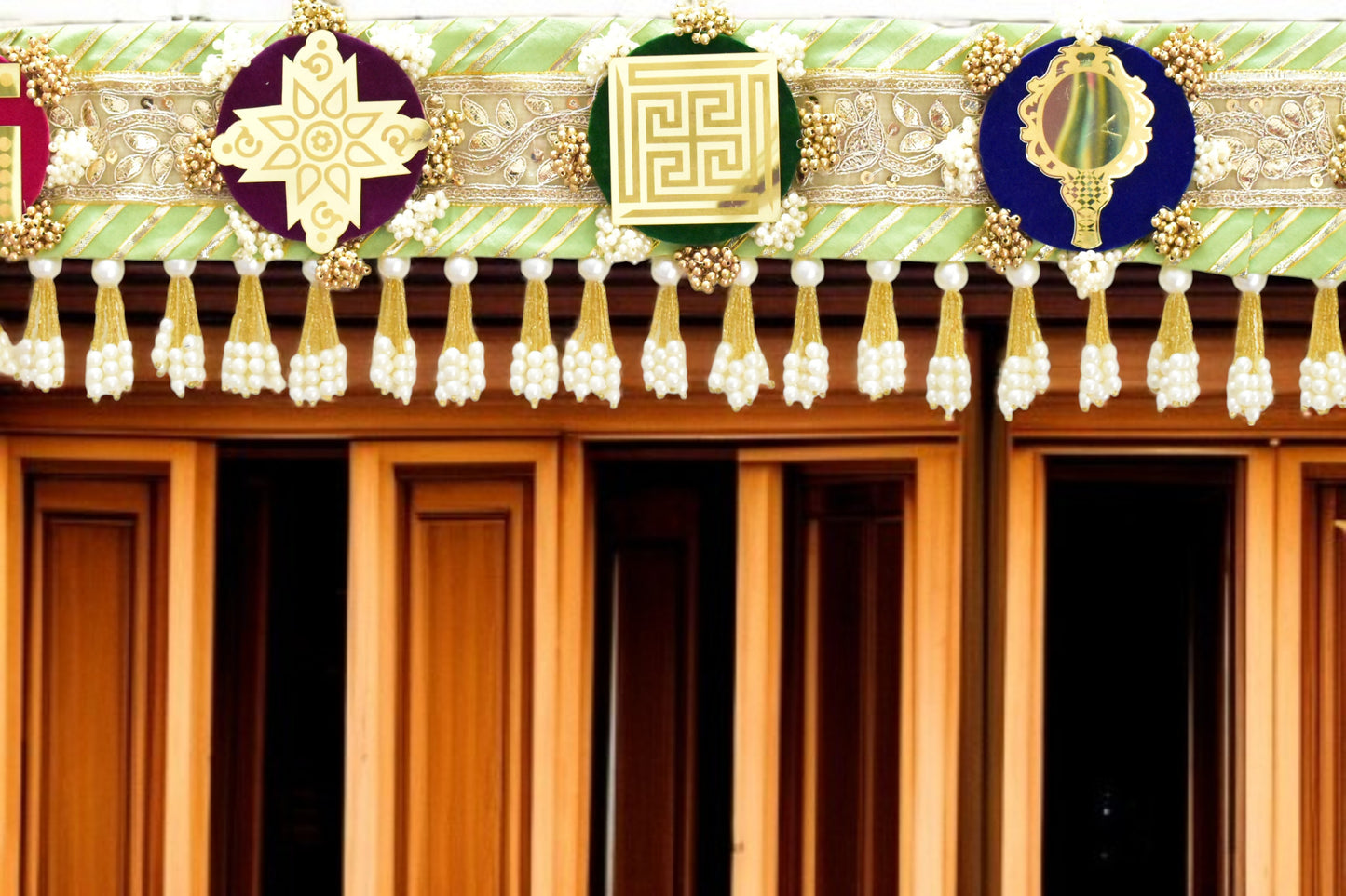 Green handcrafted Ashthamangala toran with traditional mirror work and 8 sacred symbols, ideal for ethnic home décor, door hanging, or pooja room decoration